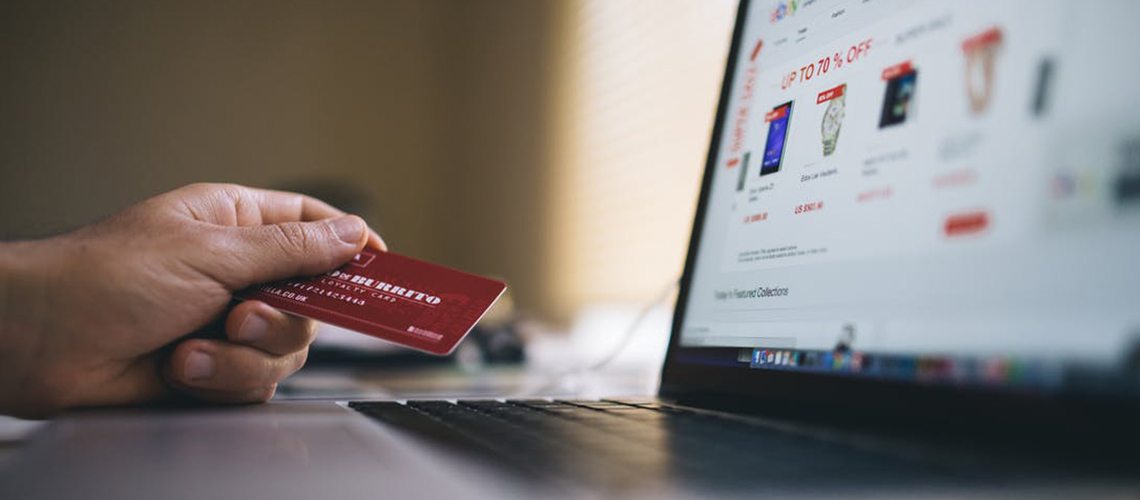 Person holding credit card, ready to use an ecommerce shop